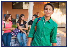 Student wearing backpack poses outside