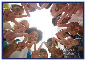 Students put their fingers together to make a star shape